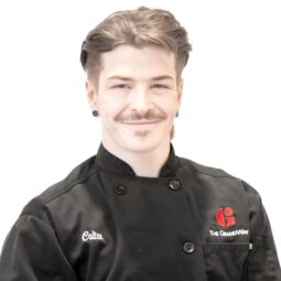 male with dark hair wearing chef jacket