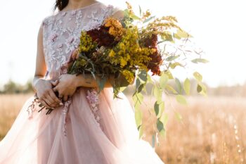bride holding fall flowers