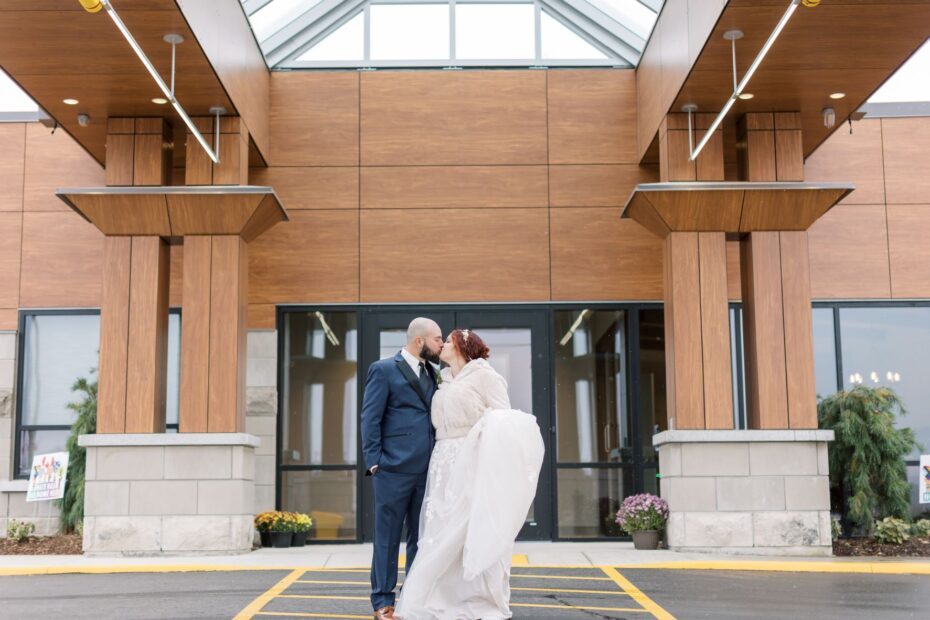 couple kissing outside of GrandWay front doors