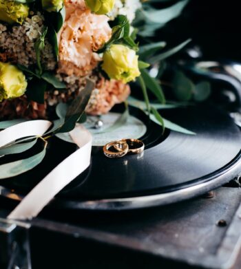 wedding rings on record with flowers