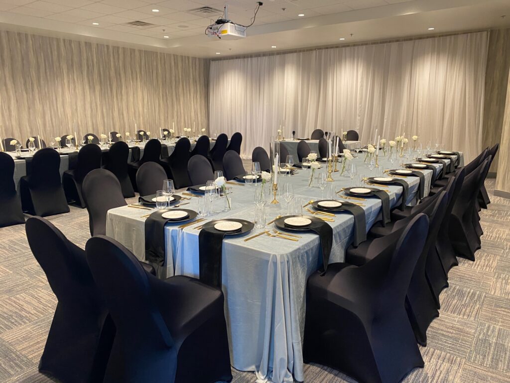 long tables with black and gold linen/chair cover accents