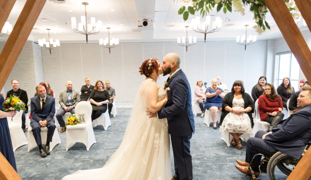 couple kissing at alter