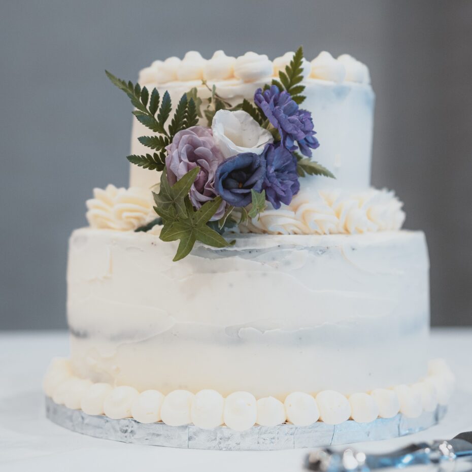 white cake with purple and white flowers